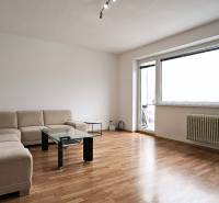 Living room in a 3-room apartment with a corner sofa and a wooden decor floor.
