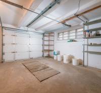 A garage in a family house on Kpt. Jaroš Street in Trenčín with storage shelves.