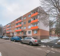Apartment building on Bezručova Street in Trenčín with parked cars and snowy surroundings.