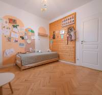 Children's room in a 3-room apartment, wooden wall paneling, floor with wood decor.
