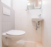 Bathroom in a 3-room apartment with white tiles and a wall-hung toilet.