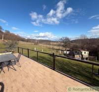 The terrace of a family house in Lukovištia with a view of the garden and the countryside.