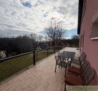 A terrace in a family house in Lukovištia with a view of the garden and the surrounding countryside.