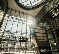 Glass atrium, Vienna Gate on Kopčianska in Bratislava-Petržalka, with an information board.