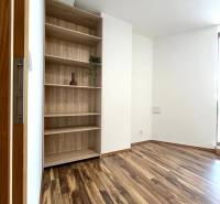 Storage shelf and floor with wood decor in a 3-room apartment.