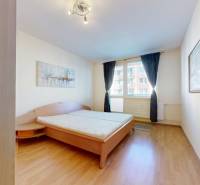 Bedroom in a 3-room apartment with a bed and a wooden decor floor.