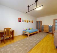 Children's room in a 3-room apartment with a bed, a desk, and a floor with a wooden decor.