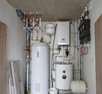 Technical room with a boiler and a furnace, visible pipes and measuring instruments.