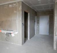Unfinished walls and installations in a 3-room apartment.