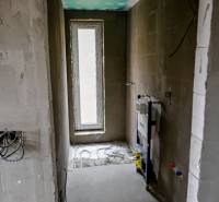 Interior of a 3-room apartment with raw walls and preparation for a sanitary corner.