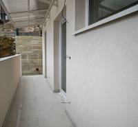 Exterior of a 3-room apartment in Stará Ľubovňa with a white floor and a canopy.