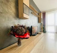 Living room with wood-patterned flooring and stylish furniture in a 3-room apartment.