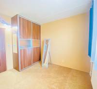 A room in a 3-room apartment with a sliding wardrobe and a beige carpet.
