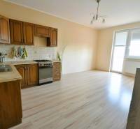 Kitchen in a 2-room apartment with wooden decor and kitchen unit.