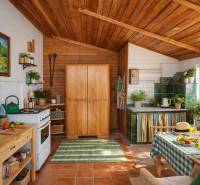 A kitchen in a family house with a rustic wooden ceiling and furniture, green tiles by the counter.