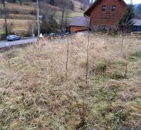 Land - housing in Oščadnica, with a view of nature and surrounding houses.
