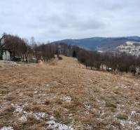 A sloped residential plot in Skalité with a view of the surrounding hills and the village.