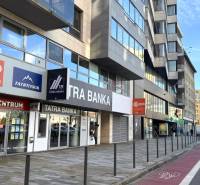 Building on Dunajská Street in Bratislava - Old Town with advertisements and entrances to offices.