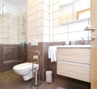 Bathroom with tiles and a shower in a 3-room apartment.