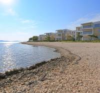A view of the coast with buildings and the sea in Sukošan, ideal for relaxation.