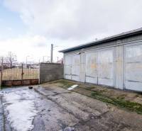 Gate and metal warehouse with a concrete area on Nádražná Street in Šenkvice.