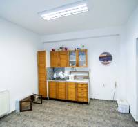 The interior of the warehouse with halls includes a kitchen unit, decorations, and a tiled floor.