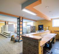 Interiors of warehouses and halls with entrance reception, shelves, and lighting.