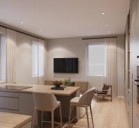 A simple interior of a one-room apartment with a kitchen and living area, wooden decor flooring.