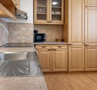A kitchen in a 3-room apartment with wooden decor and modern equipment.
