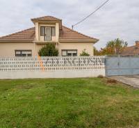 A family house in Veľké Dvorníky with a fence and a well-maintained garden.