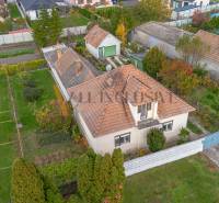 A family house in Veľké Dvorníky with a spacious garden, garage, and cultivation areas.