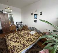 A bedroom in a 4-room apartment with carpet, decorations, and a wooden decor floor.