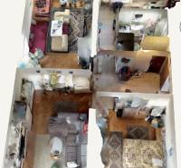 Interior of a 4-room apartment with a wooden decor floor and furniture of various styles.