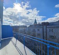 A sunny balcony with a view of the rooftops of buildings in Bratislava - Old Town, Poštová.