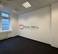 Offices with carpeted floors and large windows.