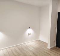 A family house with white walls, dark doors, and a wooden decor floor.