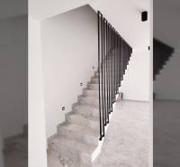 A staircase with marble decor and metal railing in a family house.
