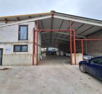 Warehouses and halls on Strojnícka Street in Prešov with a car in front of the building.