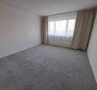 A spacious room in a 3-room apartment, with large windows and curtains.