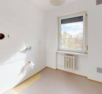 Empty room in a 3-room apartment with a window and a radiator.