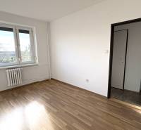 A bright room with wood-patterned flooring in a 3-room apartment.