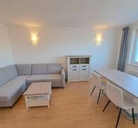 Living room in a 4-room apartment with a corner sofa and a dining table.