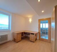 A study in a 4-room apartment with a wood-patterned floor and a writing desk.