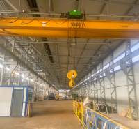 Production facilities with industrial cranes and stored materials.