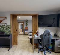 Interior of a family house with a work corner, piano, and wooden decor flooring.