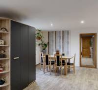 A dining room in a family house with wooden floor decor and spacious cabinets.