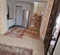 Family house with a staircase, carpet, and patterned floor with a wooden decor.
