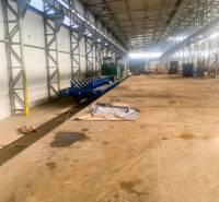 Production facilities with railway tracks, steel structures, and stored materials.