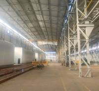 Large manufacturing spaces with high ceilings and steel structures.