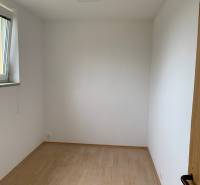A small room with white walls and a floor with a wood decor.